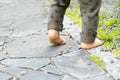 Close up of the bare foot of the child walking on stone pavement and copy space Royalty Free Stock Photo