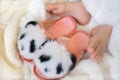 Close up bare foot in the morning at home, relaxing. Funny fluffy panda slippers. Comfort aesthetics style