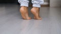 Close up of barefoot young female walking on warm heated wooden floor at home. step in her bare feet relaxing enjoy free Royalty Free Stock Photo