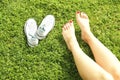 Female bare feet on mawed lawn grass. Young woman resting outdoors barefoot, take a break concept. Student on college campus yard. Royalty Free Stock Photo