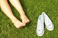 Female bare feet on mawed lawn grass. Young woman resting outdoors barefoot, take a break concept. Student on college campus yard. Royalty Free Stock Photo