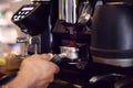 Close Up Of Barista In Cafe Using Machine To Make Coffee