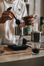 Close up barista carefully measuring coffee grains on a digital scale