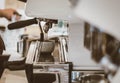 Close-up of barista hand making cup of coffee with coffee maker machine in restaurant or coffee shop. Lifestyles of modern life in Royalty Free Stock Photo