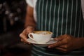 Close up of barista holding cappuccino