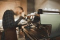 Close-up barista photo of steaming milk for coffee on a professional coffee machine. Barista`s husband warmes the milk in pitcher Royalty Free Stock Photo