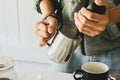 Close- up .Barista is  steaming, milk frother  latte art in coffee mug at home in the morning Royalty Free Stock Photo