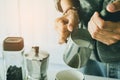 Close- up , Barista is steaming, milk frother latte art in coffee mug at home in the morning with sunset Royalty Free Stock Photo