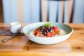 close-up of barley porridge with a swirl of berry compote