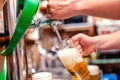 close-up of barman brewing a draft beer at pub. Bartender pourin Royalty Free Stock Photo