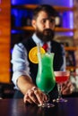 Close up of barman decorate blue lagoon cocktail