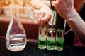 Close up barman hands preparing green mexican cocktail drink at Royalty Free Stock Photo