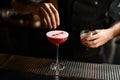 Close-up of bartender decorating alcohol cocktail on bar counter Royalty Free Stock Photo