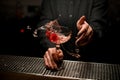 Close-up of bartender holding splashing drink with hands