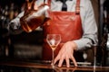 Close up bartender pouring bright red alcohol cocktail into fancy glass Royalty Free Stock Photo