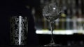 Close up of a bartender putting ice cubes into the small empty cocktail glass. Media. Details of making a drink with Royalty Free Stock Photo