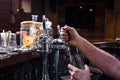 Close-up of bartenders hands pouring beer Royalty Free Stock Photo