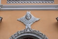 Close - up of a bas-relief with an angel on an old pink wall with cracked plaster Royalty Free Stock Photo