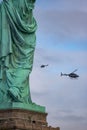 New York, New York - October 11, 2019 : Helicopters flying past the Statue of Liberty