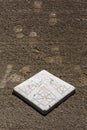 Close up of baseball base plate on a freshly groomed dirt field Royalty Free Stock Photo