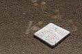 Close up of baseball base plate on a freshly groomed dirt field Royalty Free Stock Photo