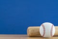 Baseball and baseball bat on wooden table with blue copy space background, sport concept Royalty Free Stock Photo