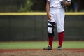 Close up of baseball players legs with red stockings standing on Royalty Free Stock Photo