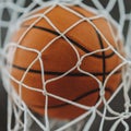 close-up image of a basketball going through a hoop.