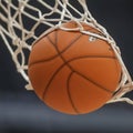 a close-up of a basketball going through a hoop.