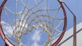 Close-up of a basketball hoop seen from below, blue sky in the background Royalty Free Stock Photo