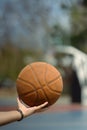 Close up of basketball player holding a ball on an outdoor court. People, sport and active lifestyle concept Royalty Free Stock Photo