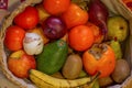 Close up view of basquet full of fruits and a head of garlic. Royalty Free Stock Photo