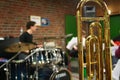 Close-up of a bass trombone tube with a fourth and fifth valve. Whorls in golden brass metal. Jazz trombones detail view with