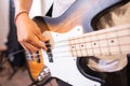 close up of a bassist& x27;s hand strumming electric guitar bass strings while checking sound Royalty Free Stock Photo