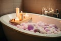 close-up of bathtub filled with soapy bubbles and aromatherapy candles