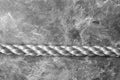 Close up of battle rope on a gray backgound. Sport and fitness equipment. Functional training