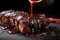 close-up of bbq beef ribs with sauce dripping off