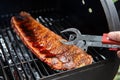 Close-up Of BBQ Roast and Smoked Pork Spareribs glazed with sauze On The Hot Charcoal Grill With Flames, Barbecue and