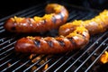 close-up of bbq sausages glazed with mustard