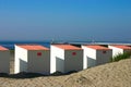 Close Up Beach Cabins with pier in background