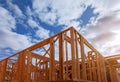 Close-up of beam built home under construction and blue sky with wooden truss, post and beam framework. Timber frame house, real Royalty Free Stock Photo