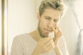 Close up bearded man portrait suffer from nose bleed using wadding tampon f Royalty Free Stock Photo