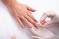 Beautician Applying Nail Oil On Man`s Hand