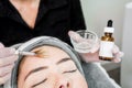 Close up of beautician cosmetologist applying chemical peel treatment on patient in a beauty spa, for skin rejuvenation, Royalty Free Stock Photo