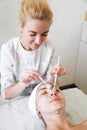 Close-up beautician doctor hand making anti-age procedure apply peeling acid Royalty Free Stock Photo