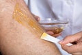 Beautician Waxing Man`s Leg Royalty Free Stock Photo