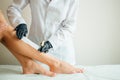 Close-up Of A Beautician Waxing Woman Leg With Wax Strip At Beauty Spa Royalty Free Stock Photo