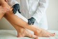 Close-up Of A Beautician Waxing Woman Leg With Wax Strip At Beauty Spa Royalty Free Stock Photo