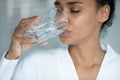 Close up beautiful African American woman drinking pure water Royalty Free Stock Photo