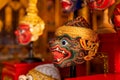 Close up of beautiful ancient traditional Thai pattern Pantomime or Khon masks are set up on wooden shelves with main focus on